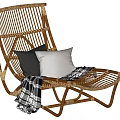 Wicker Chaise Lounge with Black and Gray Cushions and Black White Plaid Blanket