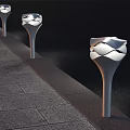 Modern Outdoor Lights With Wavy White Shades Along Stone Path At Night