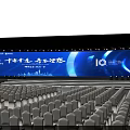 Large Event Venue With Blue Lighting Stage Backdrop Screen And Arranged Chairs