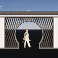 Chinese Scenic Wall with Circular Archway Lattice and Person in White Walking Holding Flower Bouquet
