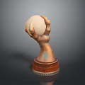Hand Sculpture With Bronze Texture Holding Light Colored Egg On Brown Base