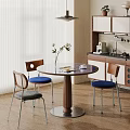 Modern Round Dining Table Set With Colorful Cushioned Chairs In Natural Light Kitchen Area
