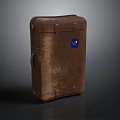 Brown Leather Suitcase With Metal Buckles And Blue Label For Travel Use