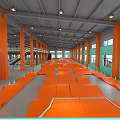 Indoor Skate Park Featuring Orange Ramps Cones Skateboarders Green Walls And Ceiling Lights