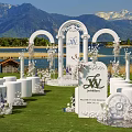 Commercial Equipment For Outdoor Wedding With White Arches Chairs Lake And Mountain Views