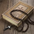 Decorative Ornament Combination With Bible Rosary Beads Metal Lantern White Candle Cross On Wooden Background