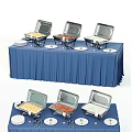 Assorted Foods On Buffet Table With Blue Tablecloth Chafing Dishes White Plates And Utensils
