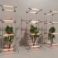 Three Modern Metal Frame Columns With Illuminated Plants And Glass Base Design