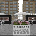 Green Food Truck In Outdoor Dining Area With White Tables Chairs Umbrellas And Menu Board