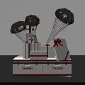 Gift Boxes With Metallic Parachutes And Red Bows On Chanel Display Base