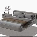 Modern Upholstered Beige Double Bed With Bedside Tables Table Lamp And Flowers