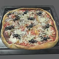 Halloween Spider Decorated Pizza On Black Baking Tray With Melted Cheese