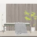 Padded Grey Ottoman Bench With Black And White Checkered Blanket And Metal Legs