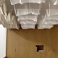 White Fabric Like Hanging Structures From Ceiling Over Wooden Wall With Square Opening And Blinds