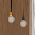 Modern Pendant Lights With Glass Bulbs Gold And Gray Bases On Wooden Wall