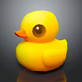 Bright Yellow Rubber Duck Toy With Large Eyes And Orange Beak On Black Surface
