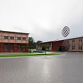 Red Brick Industrial Factory Building With 5G Signage Parking Lot Green Trees And Clear Sky