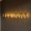 Modern Wall Lamps With Metal Frames Emitting Warm Light On Wooden Wall