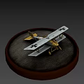 White And Yellow Model Airplane With Black Crosses On Round Gray Base