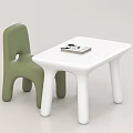 White Kids Table with Green Chair and Books for Children's Play Area