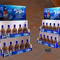 Multi Tiered Retail Display Shelves With Branded Beverage Bottles And Blue Graphics 3d model