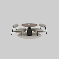 Modern Round Wooden Table with Black Metal Base and Beige Upholstered Chairs on Rug