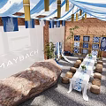 Maybach Display Area Featuring Blue White Striped Canopies Brick Walls Long Table And Stone Stools