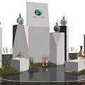 Modern Multi Level Display Stand With Copper Bottles Green Logo And Grass Decoration 3d model