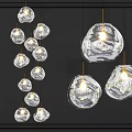 Multiple Transparent Glass Pendant Lights with Irregular Shape Hanging Illuminated in Modern Interior