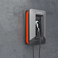 Tesla Wall Mounted Electric Vehicle Charger With Orange Accents On Gray Wall