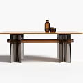 Modern Dining Table With Wooden Top And Metal Legs Featuring Brown Bottle And Small Cups