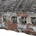 Dilapidated Industrial Factory Building With Red Brick Walls Roof Chimneys And Old Windows