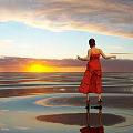 Woman in red dress standing on beach enjoying sunset with water reflection and cloudy sky