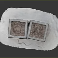 Two Square Textured Stone Storage Boxes On White Paper Surface