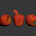 Three Fresh Red Apples on Shiny Reflective Surface with Green Leaf