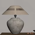 Textured Stone Base Table Lamp With Cream Fabric Shade On Wooden Table