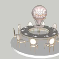 Elegant Round Dining Table Setup with White Chairs Gold Accents and Hot Air Balloon Model