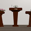 Three Wooden Podiums With Microphones And Flower Arrangements On Light Colored Wall And Wooden Floor