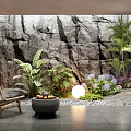 Indoor Landscape with Rock Wall Lush Greenery Flowers Wooden Chair Fire Pit and Round Lamp