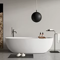 White Freestanding Bathtub with Black Globe Light Wood Column and Bath Products in Modern Bathroom