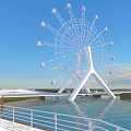 White Ferris Wheel With Glass Cabins Over Water And Green Grass Under Blue Sky