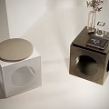 Modern Cube Shaped Side Tables White And Brass With Circular Cutouts And Plants Books Glassware