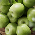 Ceramic Bowl Filled With Fresh Green Apples And Olive Branches Along With Walnuts On Wooden Table