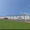Covered Parking Lot With Parked Cars Gray Pavement Green Lawn And Blue Sky
