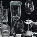 Assorted Glass Cups With Different Shapes And Designs On Reflective Black Surface 3d model