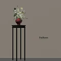 Red Vase With White And Green Flowers On Black Pedestal Against Light Colored Wall Poliform