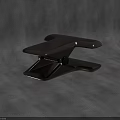 Modern Black Metal Clip With Ergonomic Grip On Textured Gray Surface
