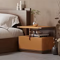 Wooden Bedroom Nightstand With Vase Green Plant And Stack Of Books