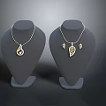 Fashionable Gold Necklaces With Teardrop And Leaf Shaped Pendants On Mannequin Displays