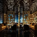 Modern Luxury Bar with Mirrored Ceiling Geometric Cutout Walls Sofa Seating and Night View Windows